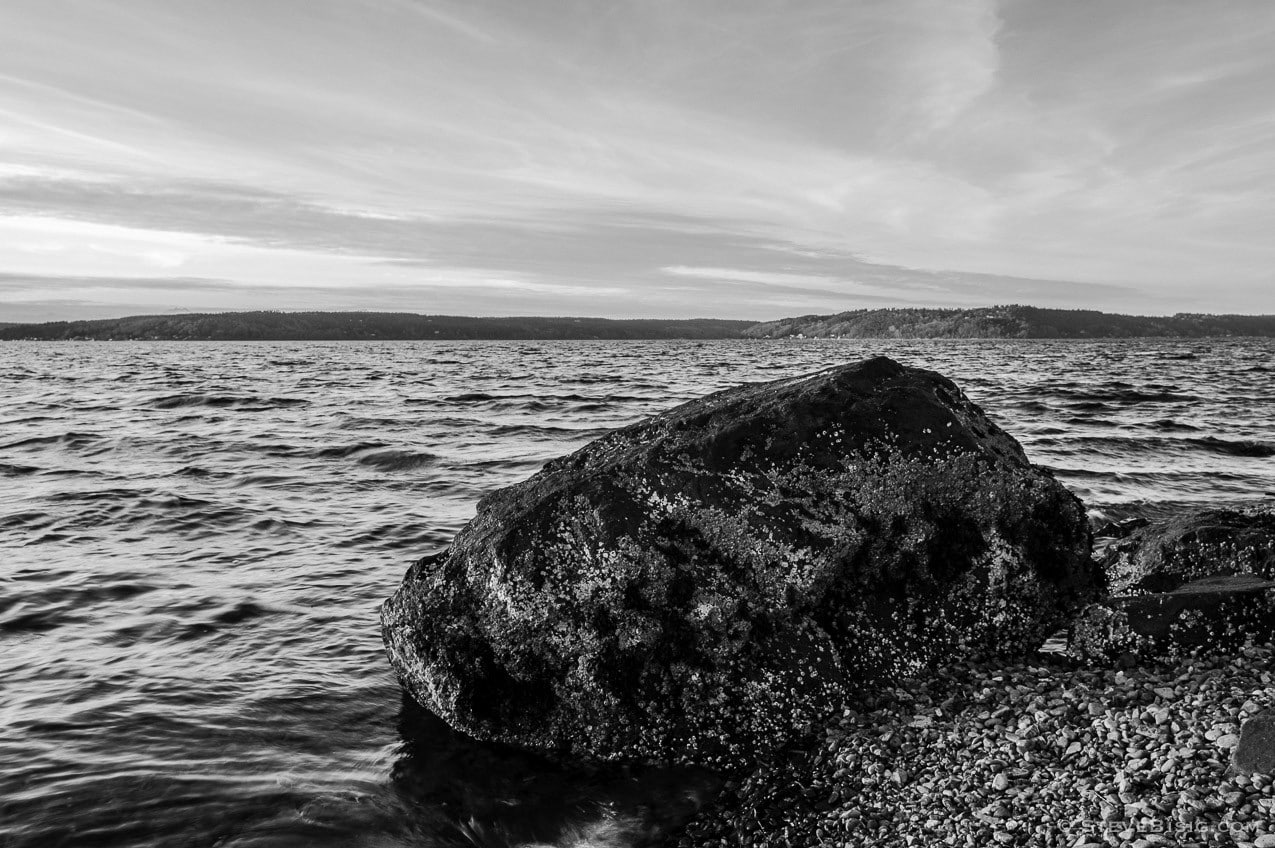 A photograph of a large rock along the shores of the Puget Sound at Browns Point, Washington.