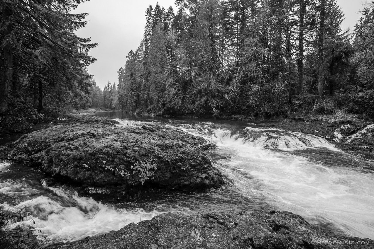 A black and white photograph of the South Fork Chehalis River at the Rainbow Falls State Park in Lewis County, Washington.