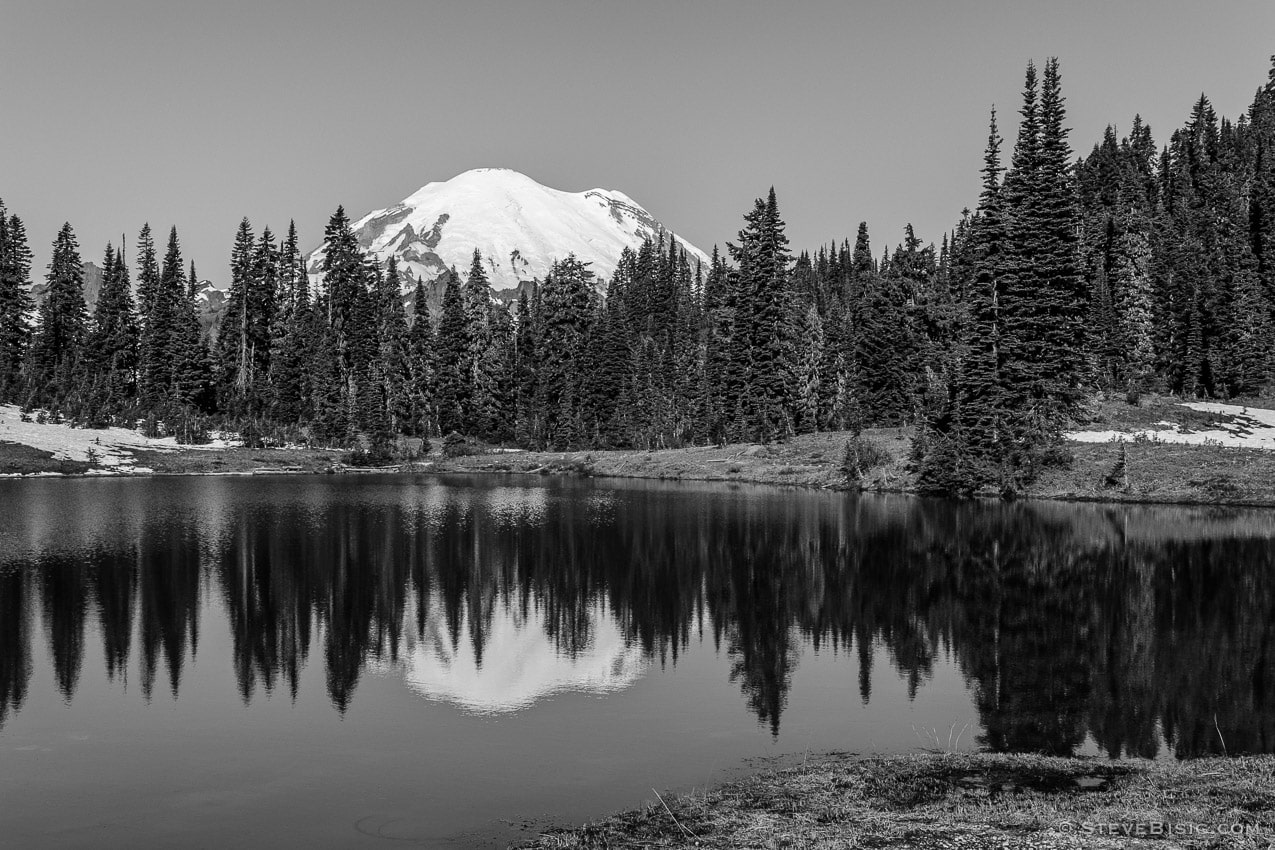 A black and white photograph of Tipsoo Lake with a reflection of a snow-covered Mt Rainier near the summit of Chinook Pass, Washington.