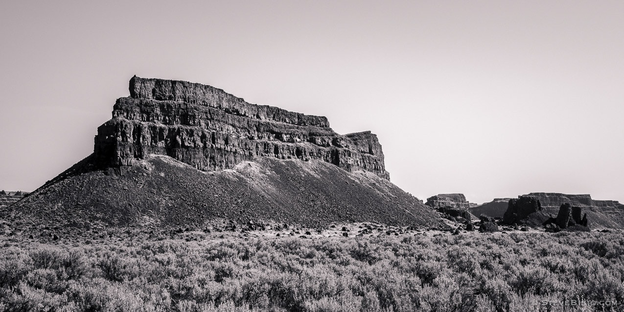 A black and white fine art panoramic photograph of Umatilla Rock at the Sun Lakes-Dry Falls State Park in Grant County, Washington.
