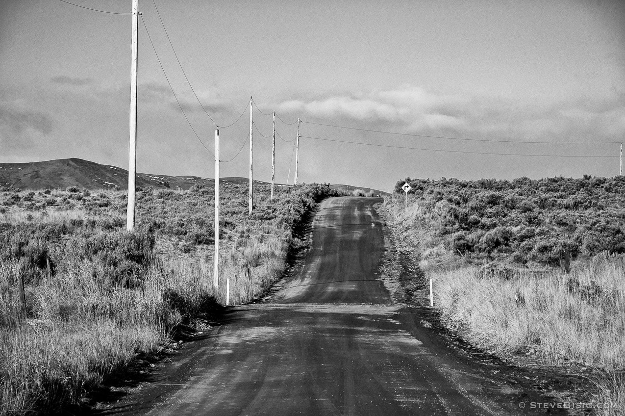 A black and white fine art photograph of Umptanum Road in rural Kittitas County near Ellensburg, Washington.
