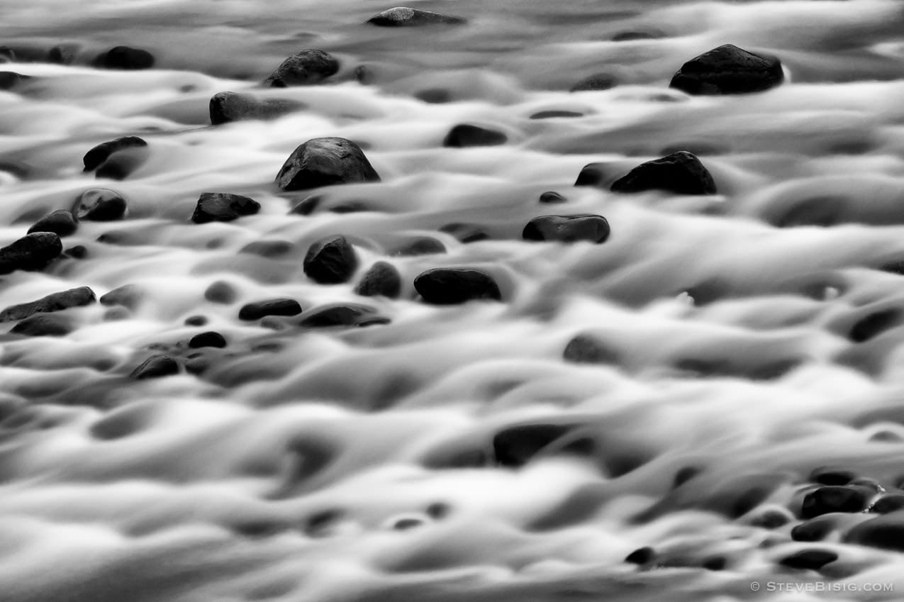 A black and white, long exposure photograph of the White River at the Federation Forest State Park, in King County, near Greenwater, Washington.